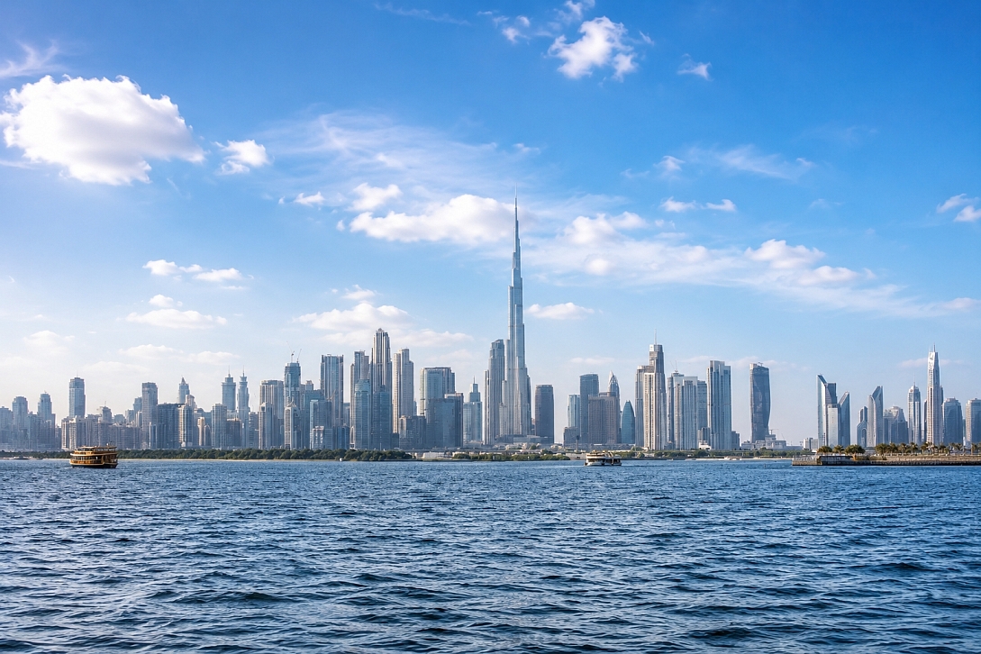 panoramic dubai skyline across blue waters